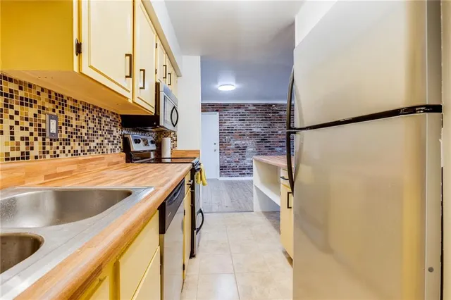 a kitchen with a sink and a refrigerator
