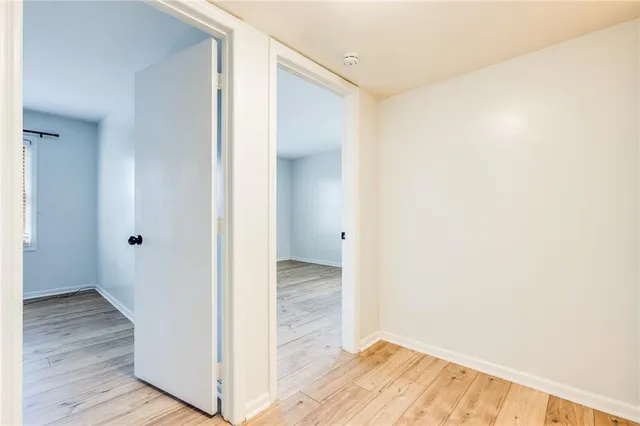 a view of hallway with wooden floor