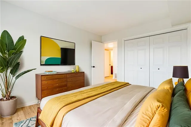 a bedroom with a bed and a flat screen television