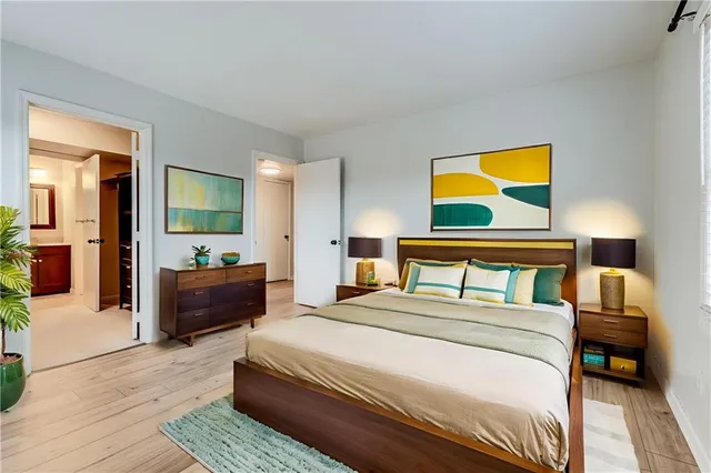 a bedroom with a bed and a painting on the wall