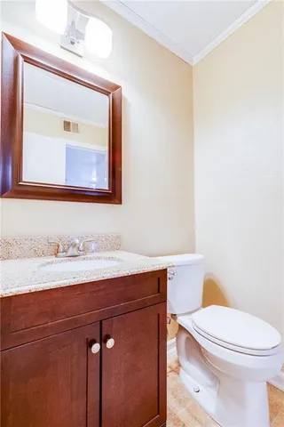 a bathroom with a toilet a sink and mirror