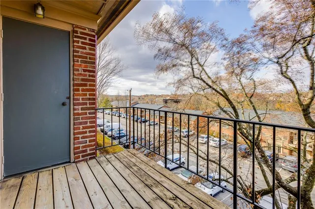 a view of balcony with wooden floor and fence