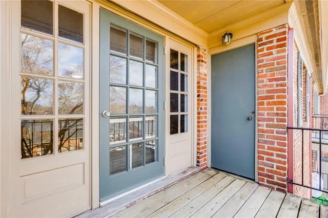 a view of a balcony with wooden floor and fence