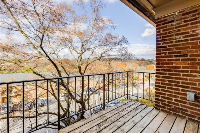 a view of balcony with wooden floor and fence