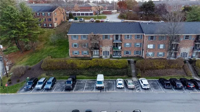 an aerial view of a house with a garden and lake view