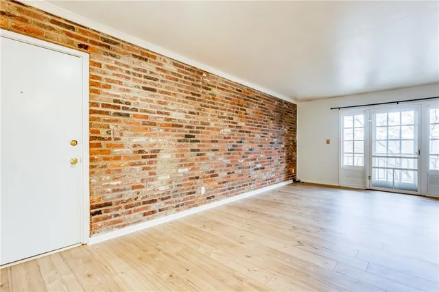 a view of an empty room and wooden floor