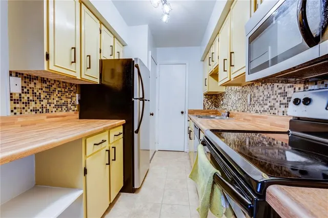 a kitchen with stainless steel appliances granite countertop a stove and a refrigerator