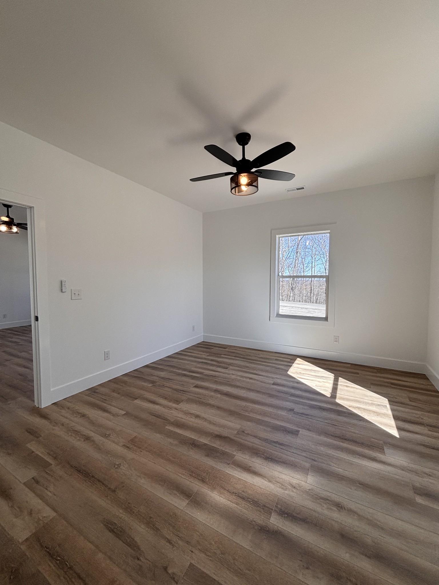 485 Baron Bluff Road Smithville, TN 37166 - Photo 22 of 28 an empty room with wooden floor and windows