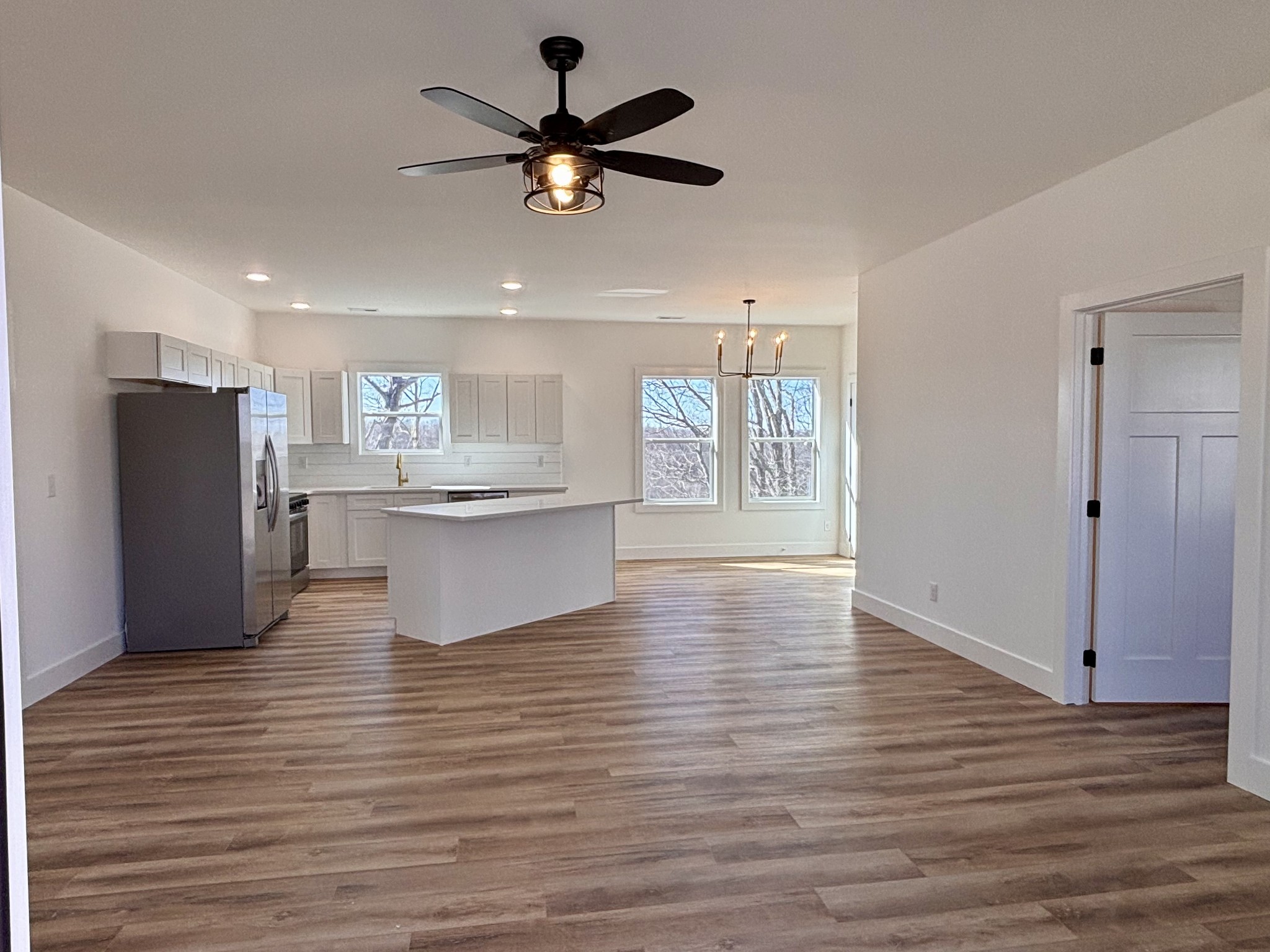 485 Baron Bluff Road Smithville, TN 37166 - Photo 9 of 28 a view of a kitchen with a refrigerator a microwave and a ceiling fan