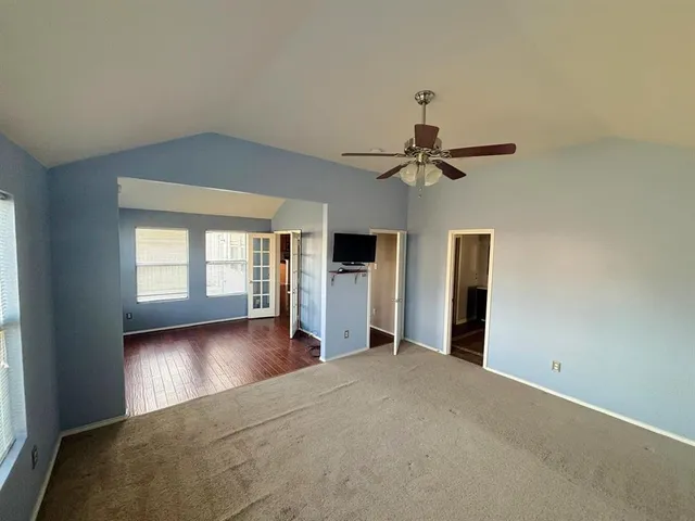 a view of a livingroom with a ceiling fan and window