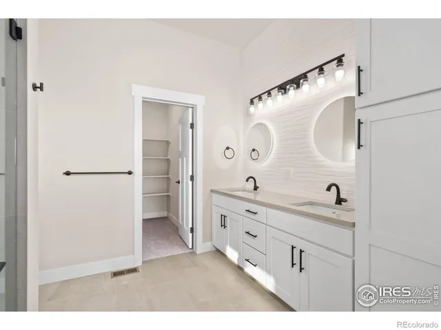 a bathroom with a shower and a sink