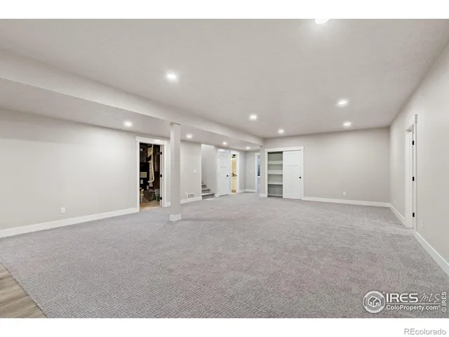 a bedroom with a bed a mirror and a window