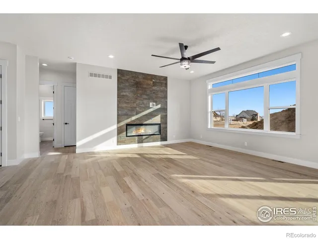 a view of an empty room with a window and workspace