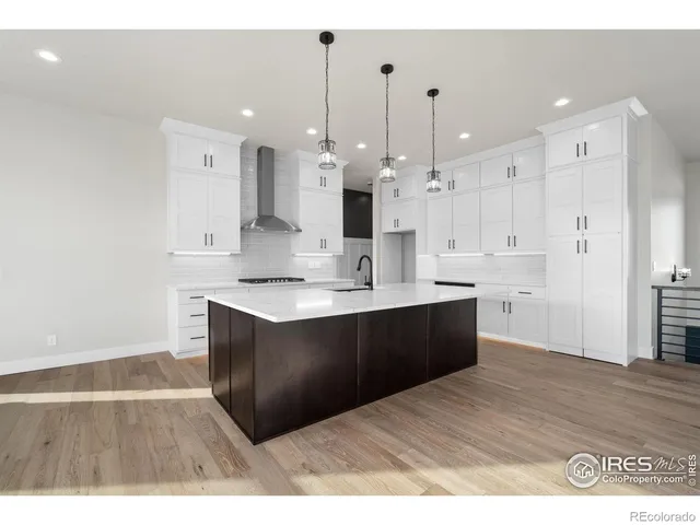 a kitchen with a sink cabinets and wooden floor