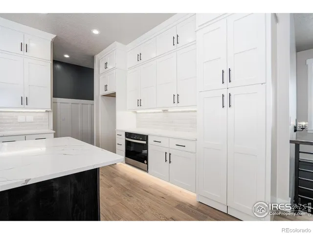 a kitchen with cabinets and a refrigerator