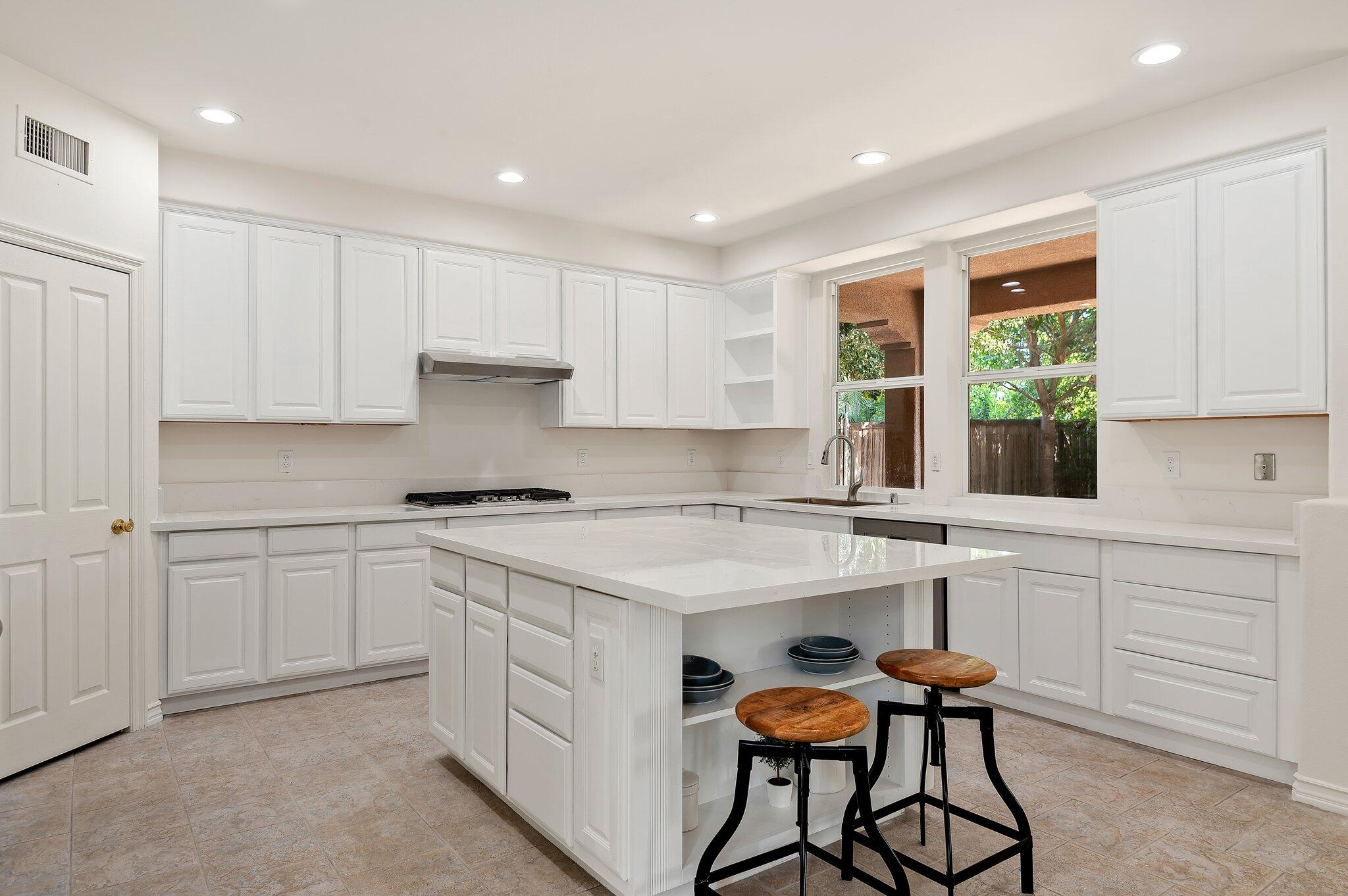 224 King Daniel Lane Goleta, CA 93117 - Photo 13 of 38 a kitchen with a sink white cabinets and white appliances