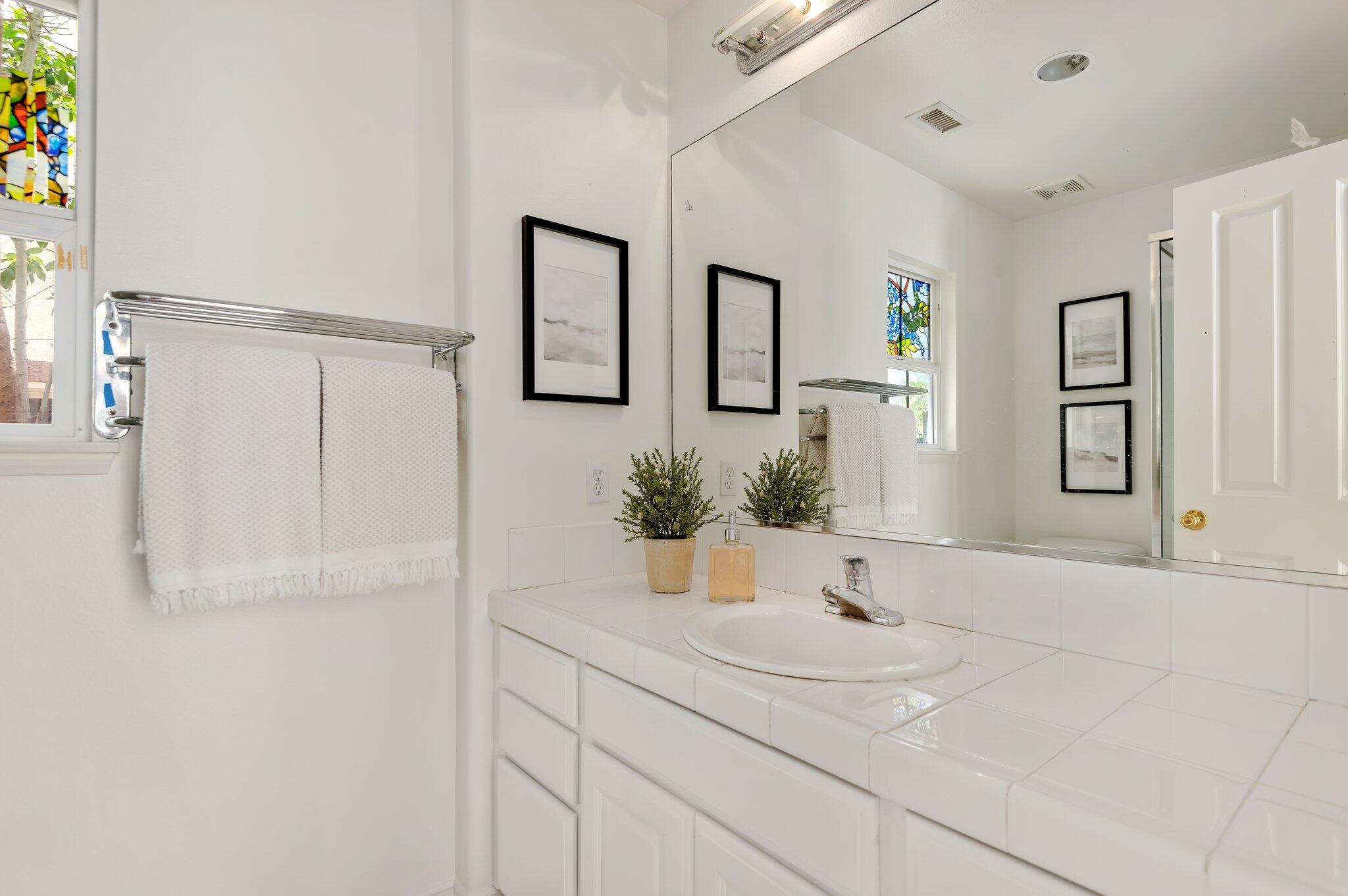 224 King Daniel Lane Goleta, CA 93117 - Photo 37 of 38 a bathroom with double vanity sink and a mirror