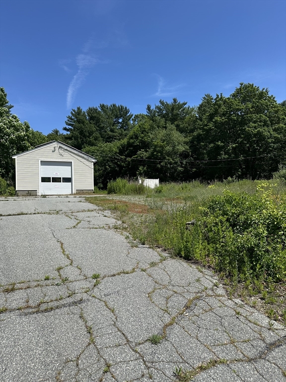 80 Phillips Street Hanson, MA 02341 - Photo 2 of 9 a view of a parking space with a large tree