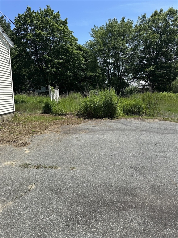 80 Phillips Street Hanson, MA 02341 - Photo 4 of 9 a view of a field with trees in background