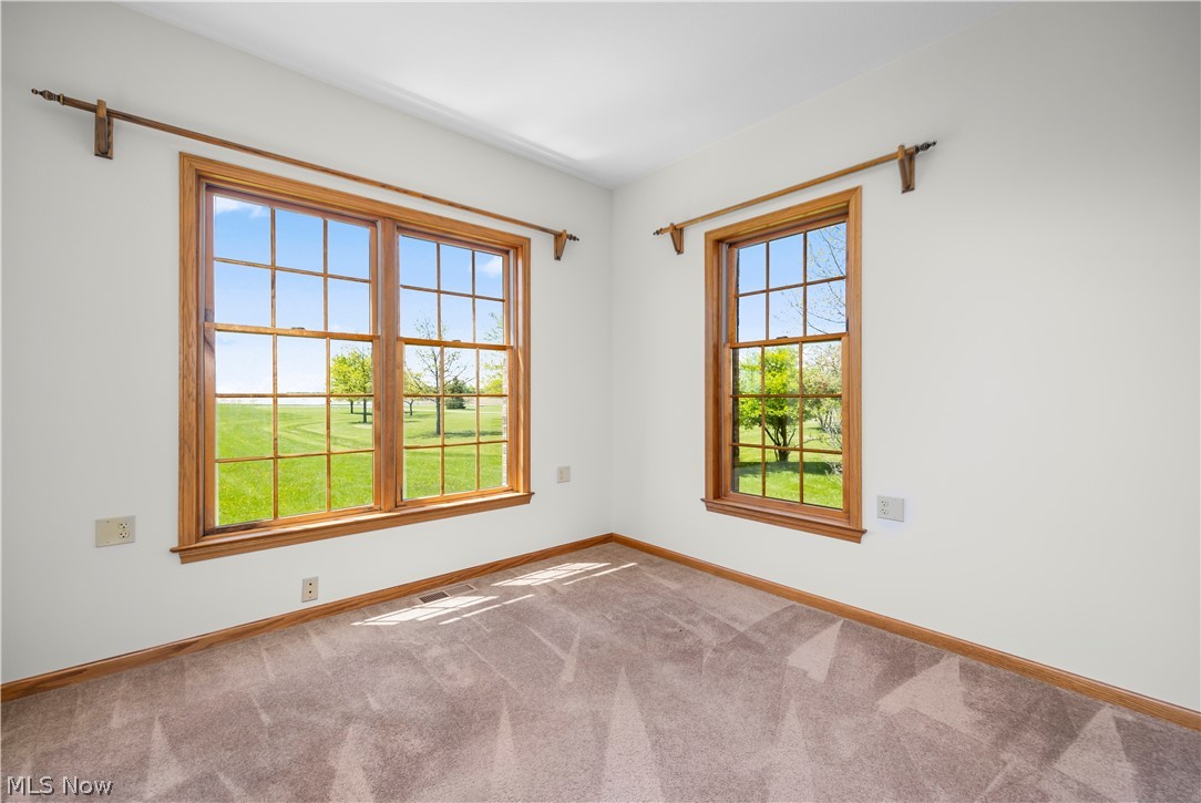 51488 Peck Wadsworth Road Wellington, OH 44090 - Photo 16 of 50 Room featuring two large windows with natural wood frames and grids, offering expansive outdoor scenery