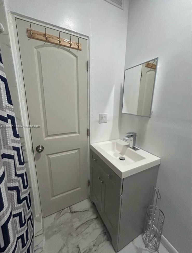 217 East 20th Street Hialeah, FL 33010 - Photo 18 of 22 a bathroom with a sink toilet and shower