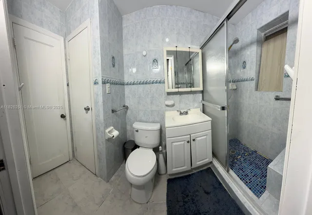 a bathroom with a toilet sink and shower