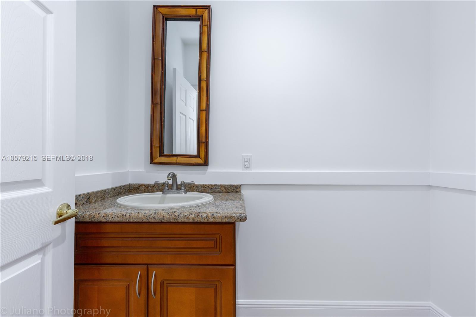 211 Southwest 29th Road Miami, FL 33129 - Photo 21 of 33 a bathroom with a sink and a mirror
