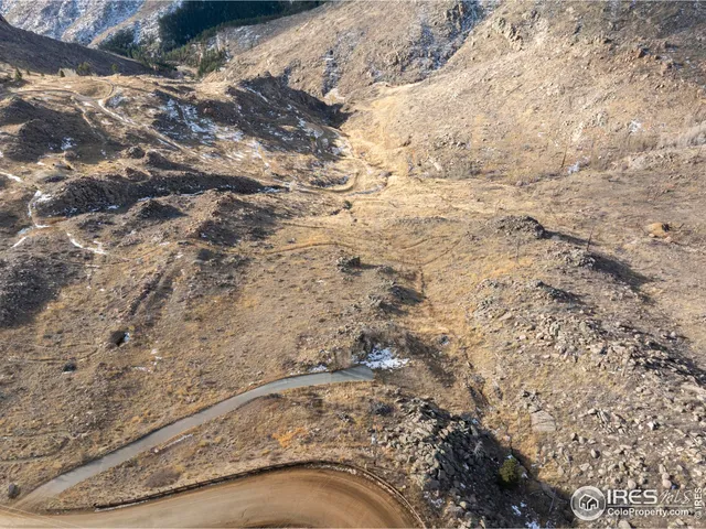 a view of a large building with mountains in the background