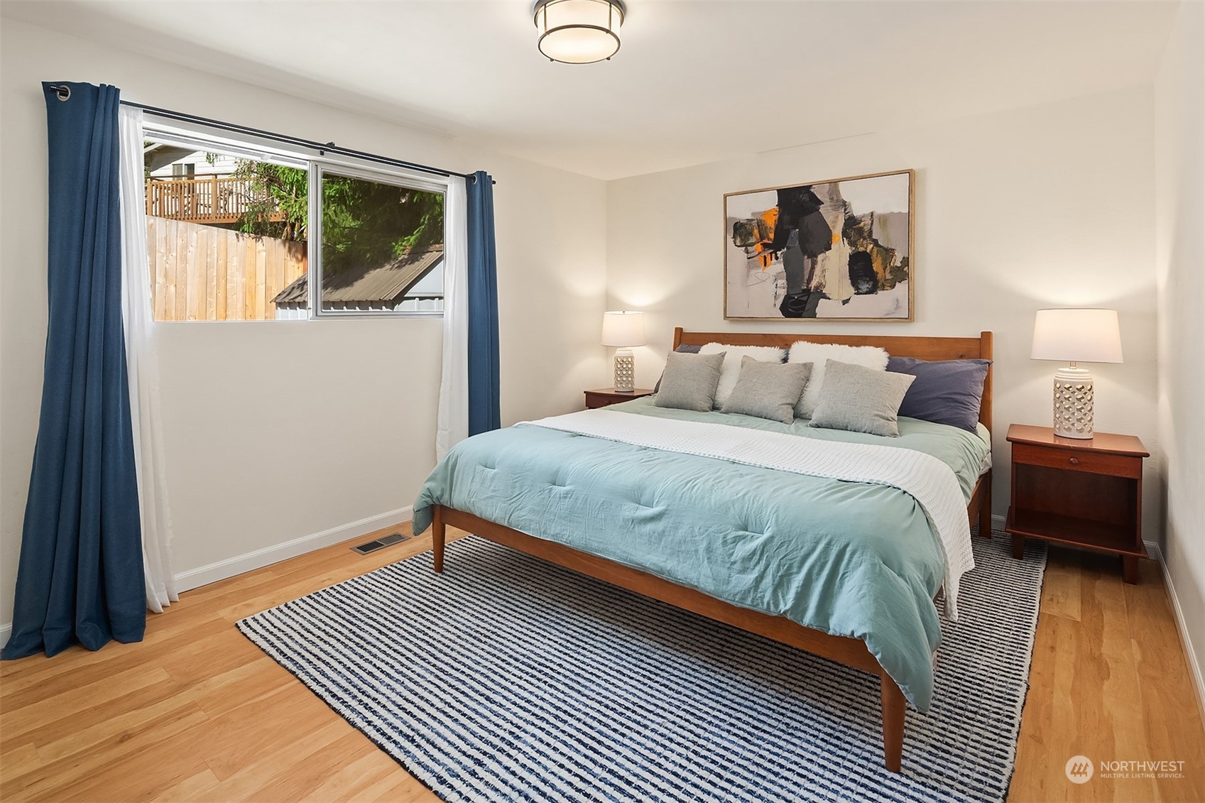 21322 2nd Drive Southeast Bothell, WA 98021 - Photo 10 of 29 a bedroom with a bed and a painting on the wall