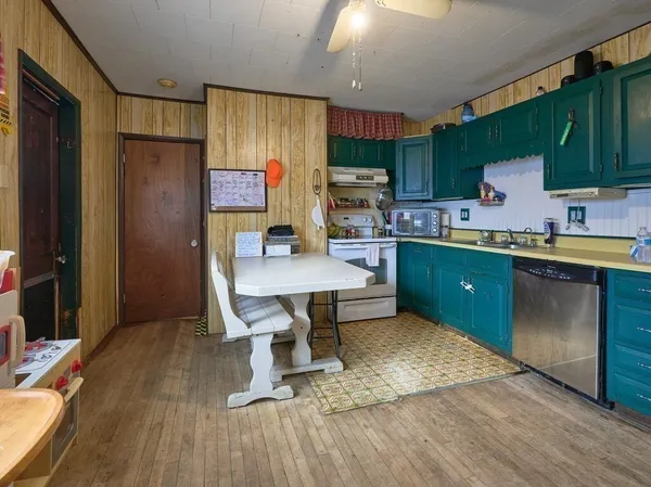 a kitchen with a sink appliances and cabinets