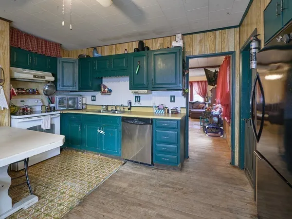 a kitchen with lots of counter top space and appliances