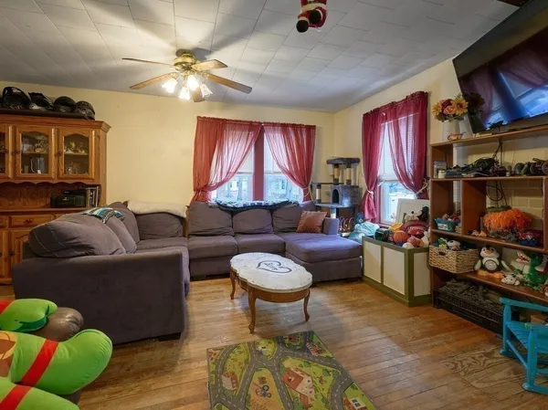 a living room with furniture a chandelier and a fireplace
