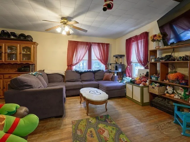 a living room with furniture a chandelier and a fireplace