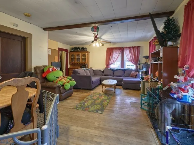 a living room with furniture a window and a flat screen tv