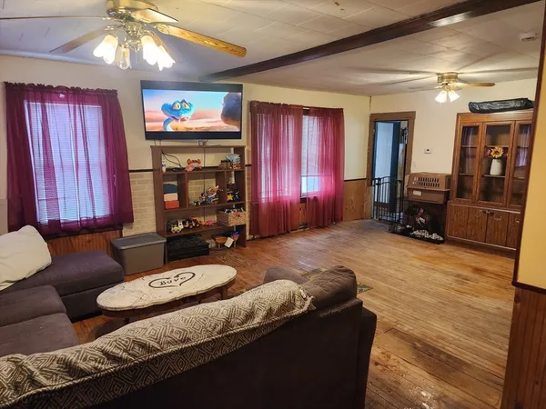 a living room with furniture and a flat screen tv