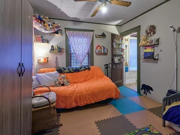 a bedroom with bed and a window