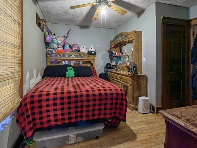 a bedroom with a bed and dresser