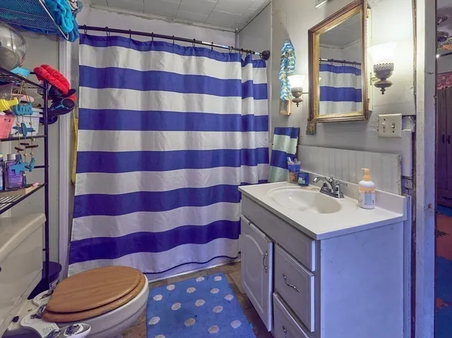 a bathroom with a sink toilet and shower
