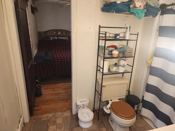a bathroom with a toilet and a shower
