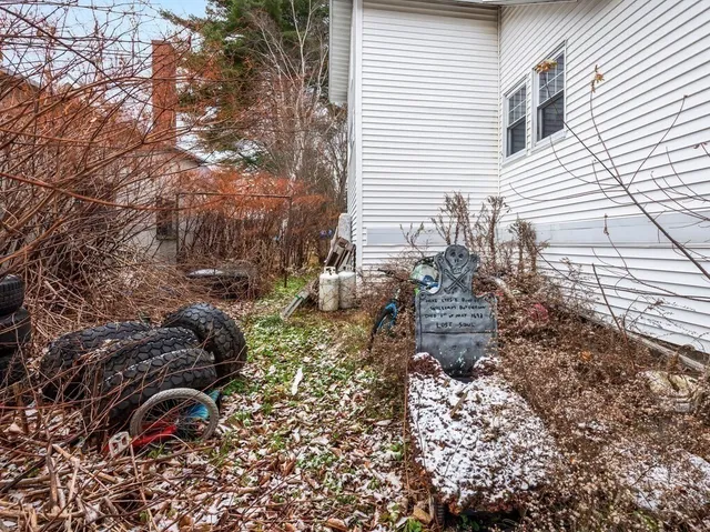 a backyard of a house with table and chairs