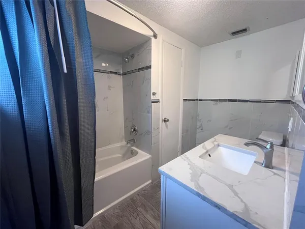 a bathroom with a sink a bathtub and a shower