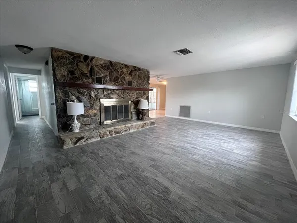 a view of a room with wooden floor
