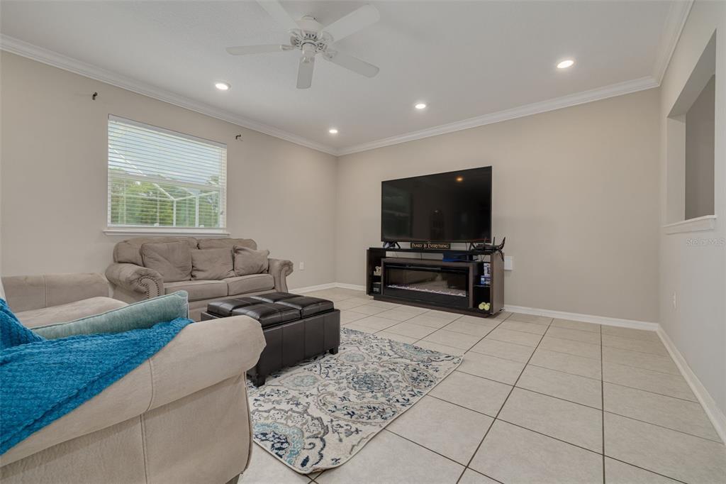 7242 Landmark Drive Spring Hill, FL 34606 - Photo 9 of 45 a living room with furniture and a flat screen tv
