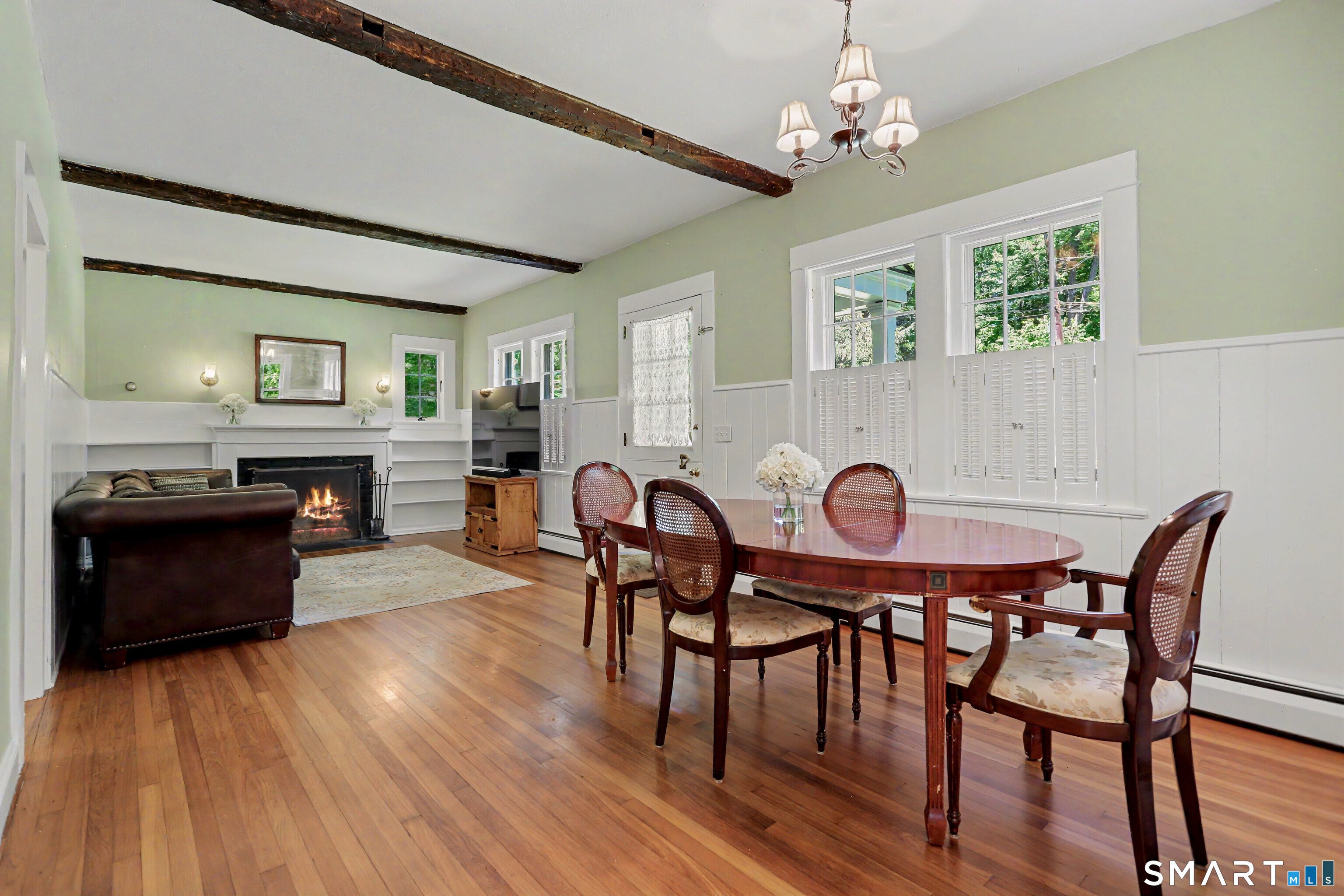 31 Vista Road Wilton, CT 06897 - Photo 7 of 34 Charming dining room featuring exposed beams, hardwood floors, and an open layout ideal for everyday living and entertaining.