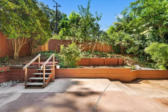 a view of balcony with wooden floor and fence