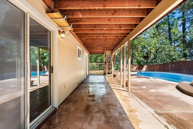 a large kitchen with kitchen island a large counter space wooden floor and stainless steel appliances