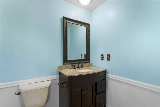 a view of an empty room with window and fire place
