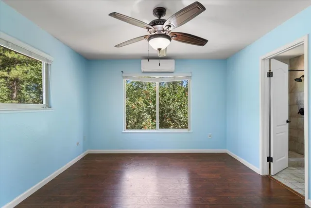 an empty room with windows and a fireplace