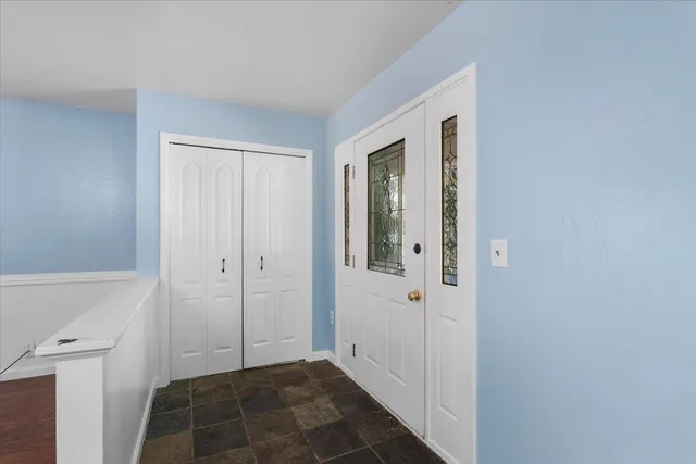 an empty room with windows and closet