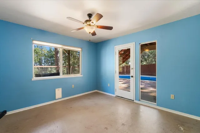 an aerial view of green landscape with trees houses and lake view